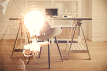 Double exposure of bulb and office interior background. Concept of idea.