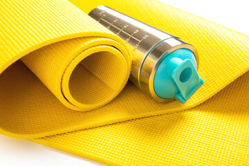 Protein shaker and yellow fitness mat