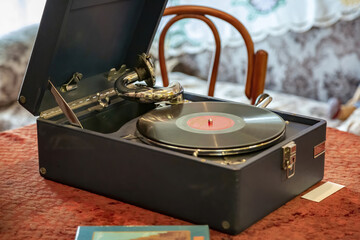 Old vintage gramophone for playing music and vinyl record as an interior item