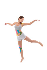 Obraz na płótnie Canvas Woman showing kinesio tapes taped to her body. Full-length portrait of woman with Bright medical kinesio tapes