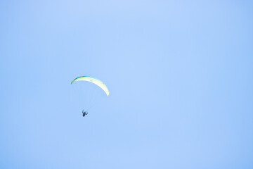 paragliding on blue sky. Copy space available on the picture
