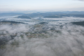 Aerial view on mountains in clouds from drone