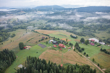 Fototapeta premium Aerial view on mountains in clouds from drone