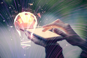 Double exposure of light bulb hologram and woman holding and using a mobile device. Idea concept.
