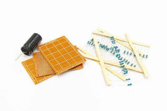 DIY Electronic Parts including capacitor, resistor, and perfboard isolated on white background