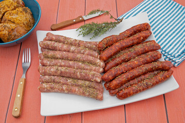 saucisses et merguez crues dans une assiette