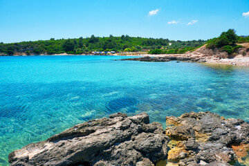 Beach, sea and sunbeds at Demircili bay in Urla, İzmir, Turkey. Holiday or travel destinations.