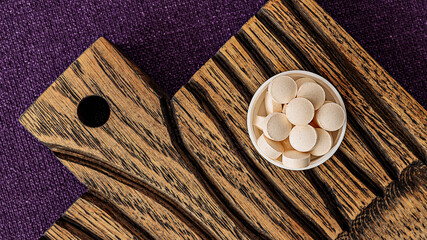 glutathione complex supplement pills on a wooden desk. dietary supplements top view. mental wellbeing and personal health concept