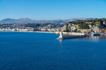 Fototapeta na wymiar City of Nice in France, pier on Mediterranean Sea with Phare de Nice lighthouse on French Riviera