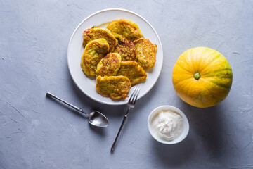 Vegetable veggie pumpkin pancakes with sour cream, summer food, delicious snacks. Pumpkin pancakes. Healthy food concept