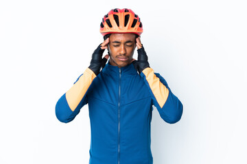 Young cyclist man with braids over isolated background with headache