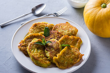 Vegetable veggie pumpkin pancakes with sour cream, summer food, delicious snacks. Pumpkin pancakes. Healthy food concept