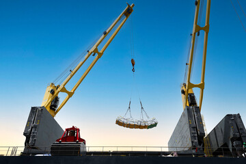 Ship crane lift jumbo sling of sugar bags load into ship hold. Bag cargo loading to ship for...