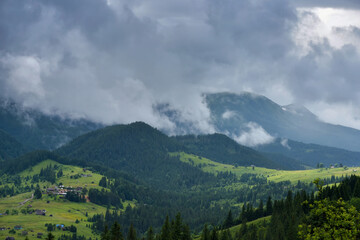 Splendid mountain valley is covered with fog after the rain. Foggy landscape. Location place Carpathian mountains, Ukraine, Europe.