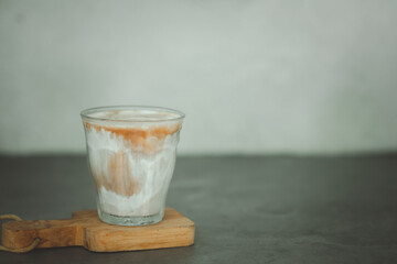 A glass of dirty coffee menu - a glass of espresso shot mixed with cold fresh milk.