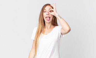 pretty thin woman smiling happily with funny face, joking and looking through peephole, spying on...