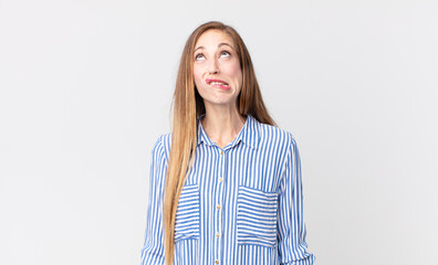 pretty thin woman looking goofy and funny with a silly cross-eyed expression, joking and fooling...