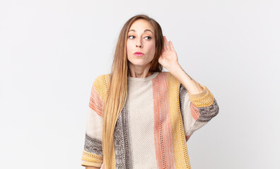 pretty thin woman looking serious and curious, listening, trying to hear a secret conversation or...