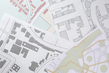 Many different cadastral maps of territory with buildings as background, top view