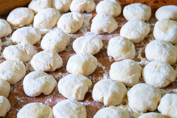 Three balls of fresh homemade wheat dough on kitchen table