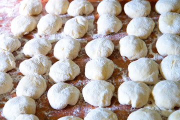 Three balls of fresh homemade wheat dough on kitchen table
