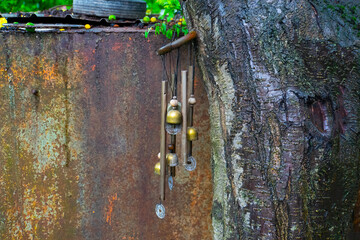 Gold wind bell under the tree at rainy day