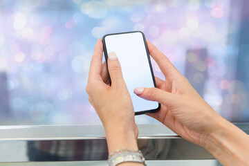 Woman’s hands holding smartphone with blank screen