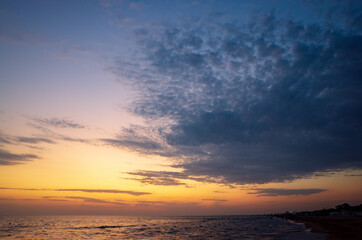 Evening sea landscape. Calm water. Large light cloud in the sky. Copy space.
