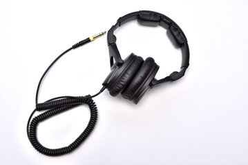 Fototapeta premium Professional studio headphones for listening, mixing and recording music. Top view of black wired stereo headphones with audio jack.