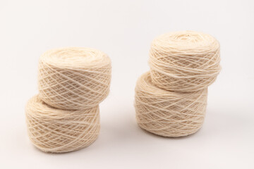 balls of light woolen thread on white background. natural wool. knitting. background