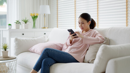 Obraz premium Young asia people 5G wifi digital device user teen girl watch read news play social media, e-commerce iot data app, pay money, remote shop retail store at home sofa couch sit easy relax happy smile.