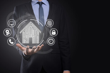 Businessman hold house icon.Smart home controlled, intelligent house, and home automation app...