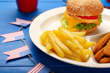 Plate with traditional American food on color wooden background, closeup