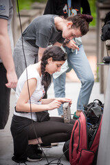 Behind the scene. Sound director and technician check equipment. Film recording outdoor