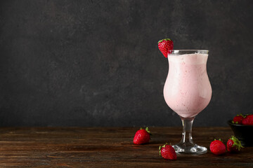 Glass of strawberry Pina Colada cocktail and berries on wooden table - obrazy, fototapety, plakaty