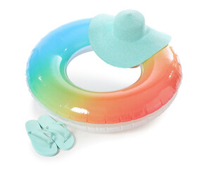 Inflatable ring, hat and flip-flops on white background