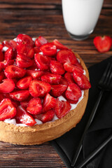 Tasty strawberry pie on wooden background, closeup
