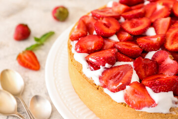 Plate with tasty strawberry pie on light background, closeup