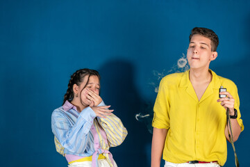 Passive smoking concept. Teen girl pinch her nose because toxic fumes from car,bad smell,air...