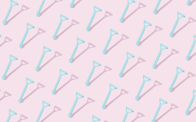 Creative pattern lay out made of plastic beard razor on pastel pink background. Plastic razor for men's shaving. Flat lay.