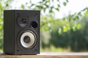 Acoustic sound speakers on nature background. Multimedia, audio and sound concept. Copy space. The...