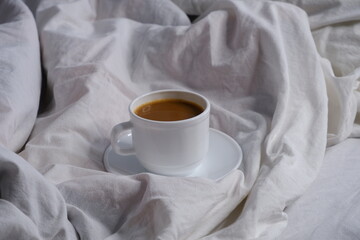 Coffee with milk in bed. Breakfast in bed. Interior. Cosiness.