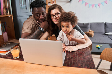 Girl emotionally looking at laptop screen and feeling surprised while watching cartoons