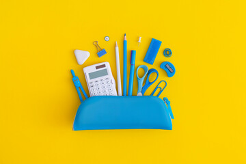 Pencil case with school stationery on a yellow background. Top view. Flat lay. Back to school...