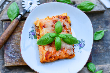   Delicious Home made keto diet  Lasagna bolognese  with  Lupin Flour, minced meat,tomato sauce and spinach  on a wooden rustic  background.Home made low carb italian meal