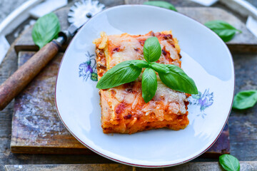   Delicious Home made keto diet  Lasagna bolognese  with  Lupin Flour, minced meat,tomato sauce and spinach  on a wooden rustic  background.Home made low carb italian meal