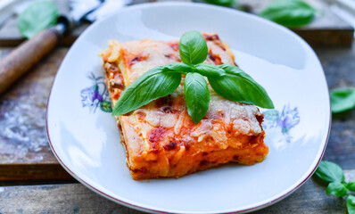   Delicious Home made keto diet  Lasagna bolognese  with  Lupin Flour, minced meat,tomato sauce and spinach  on a wooden rustic  background.Home made low carb italian meal
