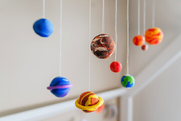 Toy planets made by kid from colorful molding clay indoor © lithiumphoto