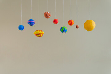 Toy planets made by kid from colorful molding clay indoor - obrazy, fototapety, plakaty