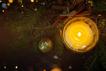 A New Year's composition with burning candles and Christmas lights in soft tinting. Greeting flyer, place for text, festive background